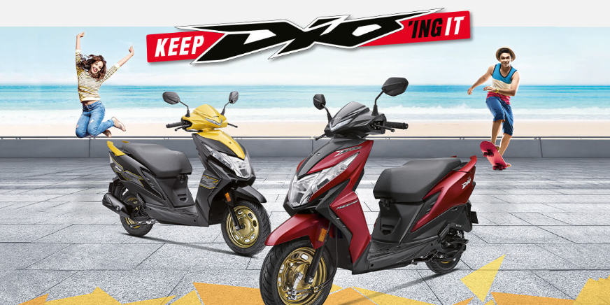 Checkout Red and Yellow Metallic Honda Dio BS6 at reasonable price exclusively at Rushabh Honda, Nashik. Best Two wheeler Honda Dealers for years.